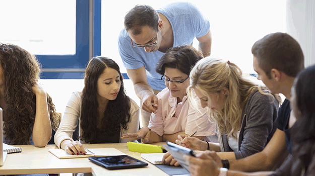 Candid of professor instructing students College Class at Work