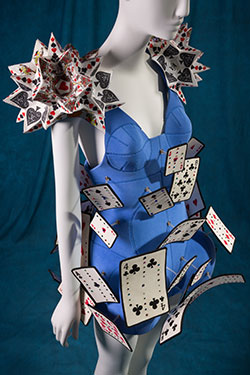 Alice in Wonderland blue mini dress with dome shaped skirt covered with playing card embellishments in white, black, red, and yellow