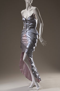 purple metallic dress with form fitting winged bustier and fishtail train