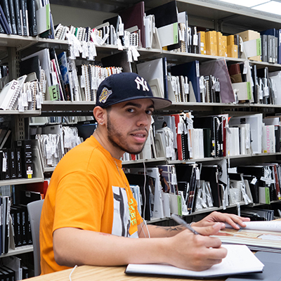 FIT student in Gladys Marcus Library studying at table