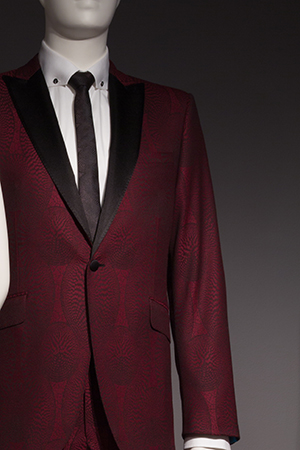 Marroon patterned suit with black tie and white shirt