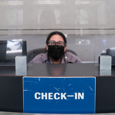 guard at FIT's front desk with a mask on