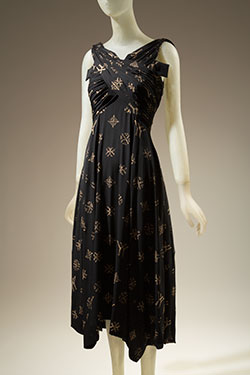 sleeveless dress of black silk with allover printed beige YY monogram and cross design resembling Louis Vuitton logo