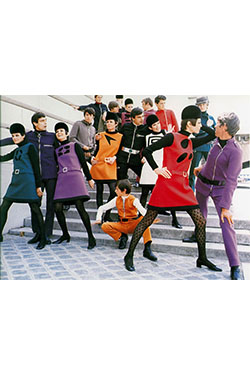 A photo of various models in "Space Age" dresses and suits