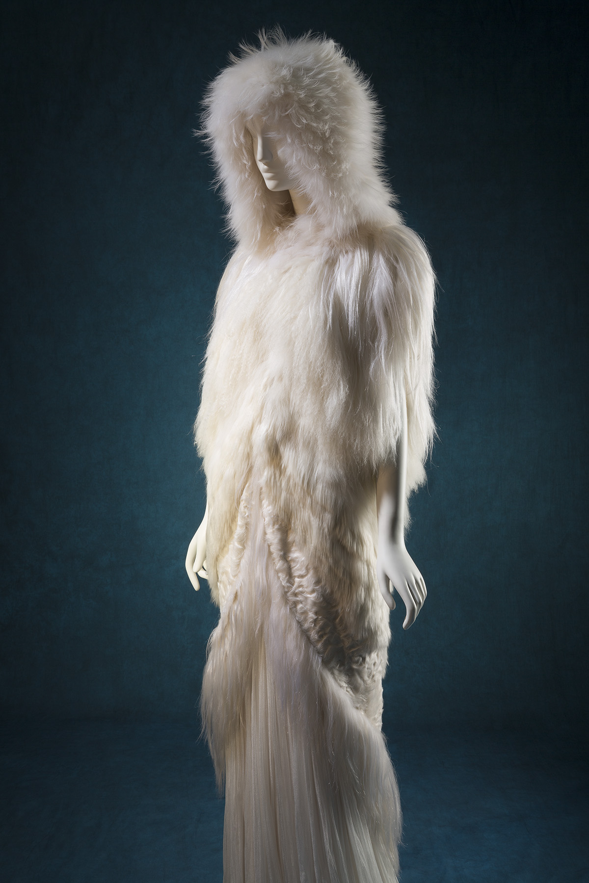 white fur hooded cape and pleated dresss ensemble