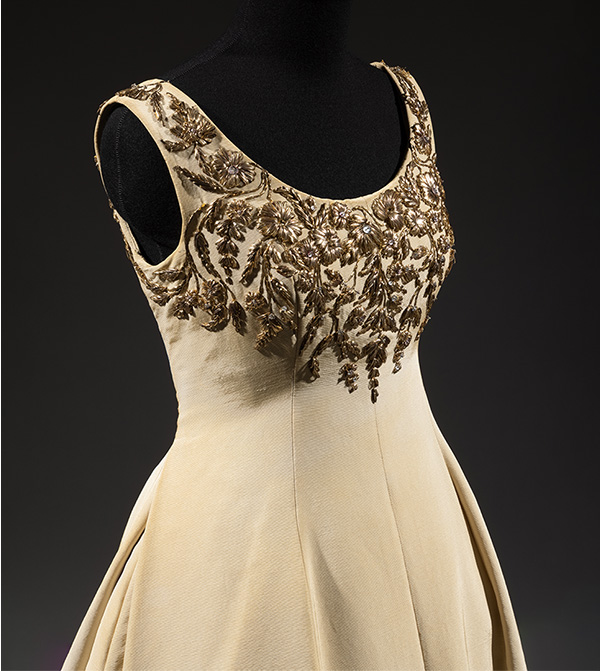 Ball gown in light beige silk ottoman, embroidered with rhinestone studded gold metallic floral motifs on bodice and straps