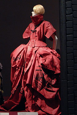 Christian Dior (John Galliano), evening dress and cross necklace, red coated silk, black ink, and metal. Spring 2006, France. Lent by Christian Dior, Paris. Photo by Irving Solero.
