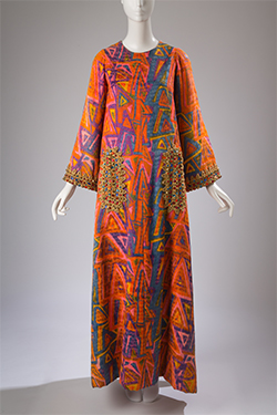 silk caftan with abstract geometric print in orange, purple, pink, blue, and yellow beaded trim