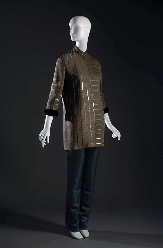 mannequin in a brown tunic with metallic stripes and black pants
