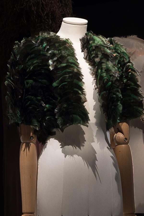 Bolero jacket covered in green feathers