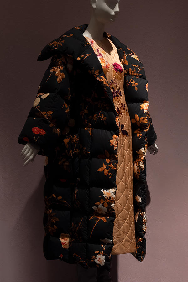 Pale orange quilted silk short sleeve dress with floral photo print with oversize black puffer coat with rose print 