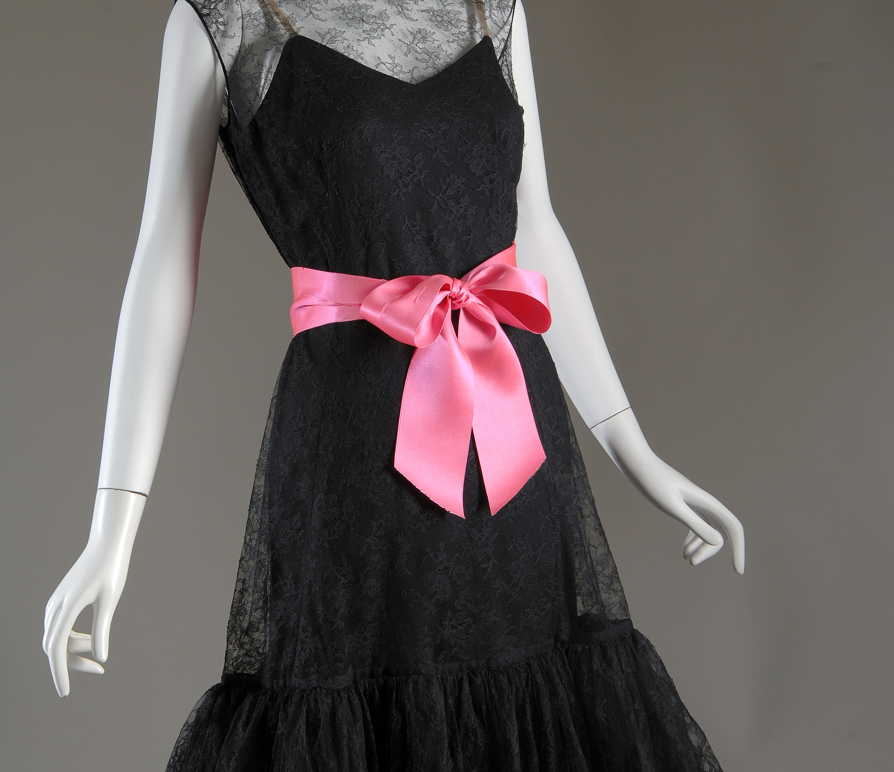 black lace cocktail dress with pink bow as belt