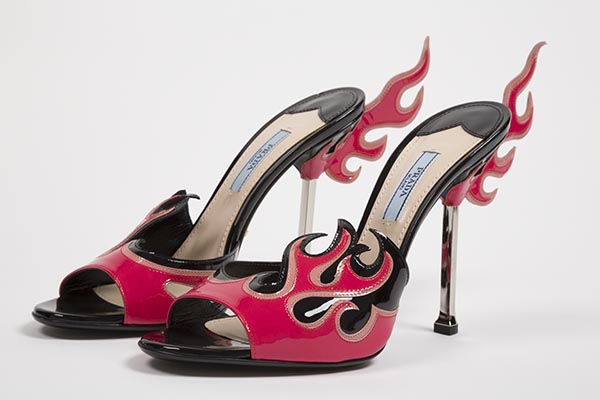 Flame high heel mules in black and shades of pink patent leather with silver stiletto heels and flame wings at heel back, also known as Hot Rod shoes