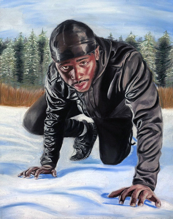 black man crouching in snow as if to take off from a running stance