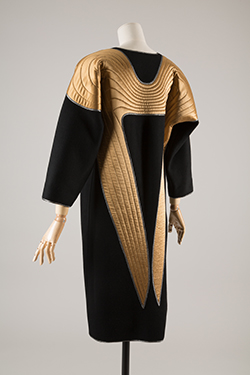 black coat and dress with quilted gold wing motif on shoulders and back