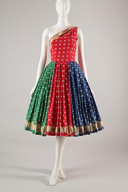 red, green, and blue one-shoulder dress with spaced print in yellow, red, blue, and black