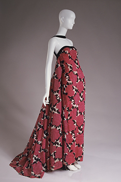 strapless evening dress and long rectangular stole with red and pink rose design on black and white leaf pattern, black velvet trim, and train