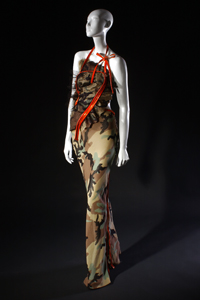 strapless camouflage evening dress with large orange plastic zippers as straps