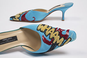 blue kitten heels with beaded work that reads whaam