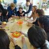 Students prepare food together in a cookery workshop.