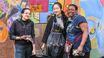 FIT students in front of murals