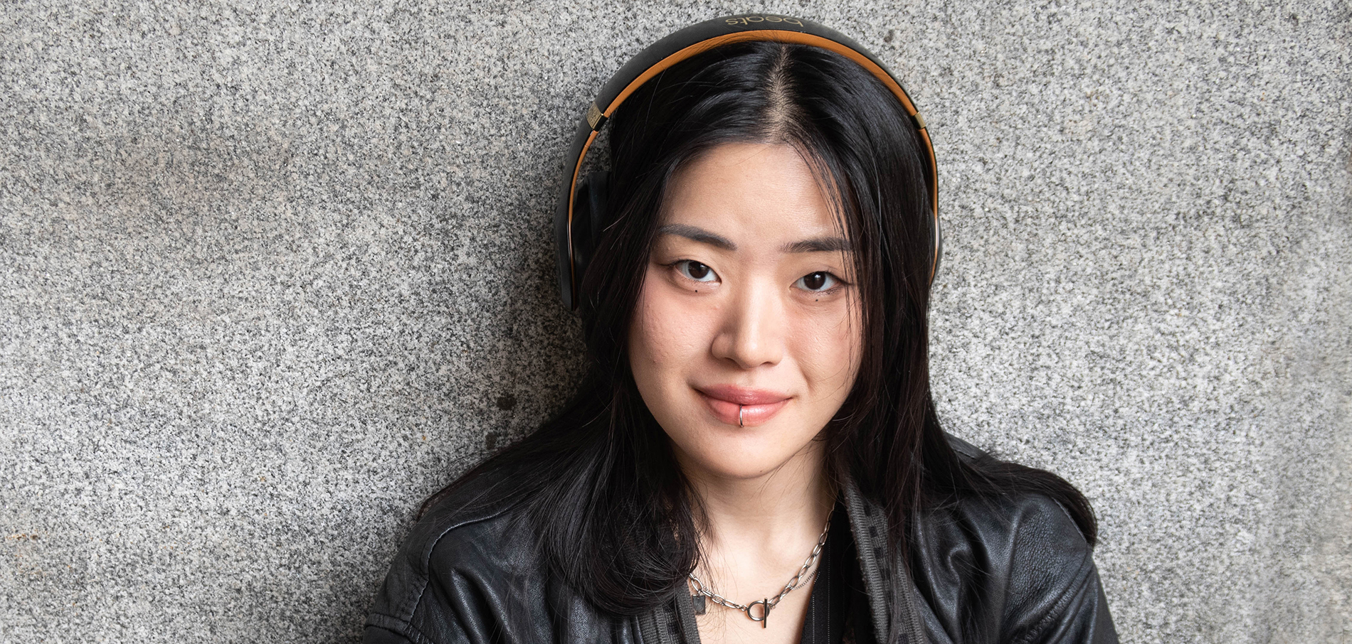 FIT student on campus wearing headphones
