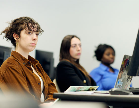 Woman listening to a faculty member speaking