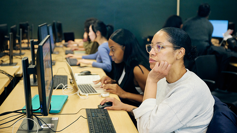 students sitting computer workstations