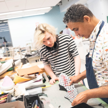 Student with teaching looking at design materials