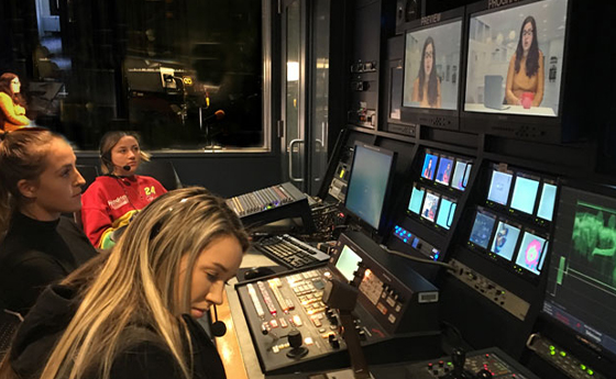 students bending over a video mixer