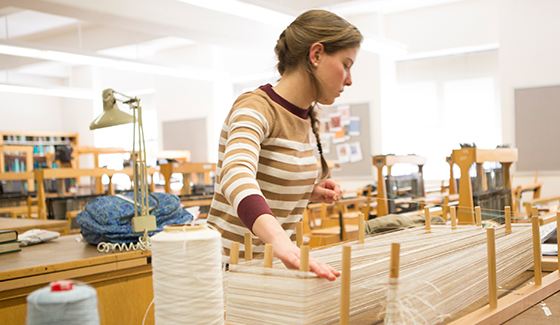 college student working with textiles at FIT