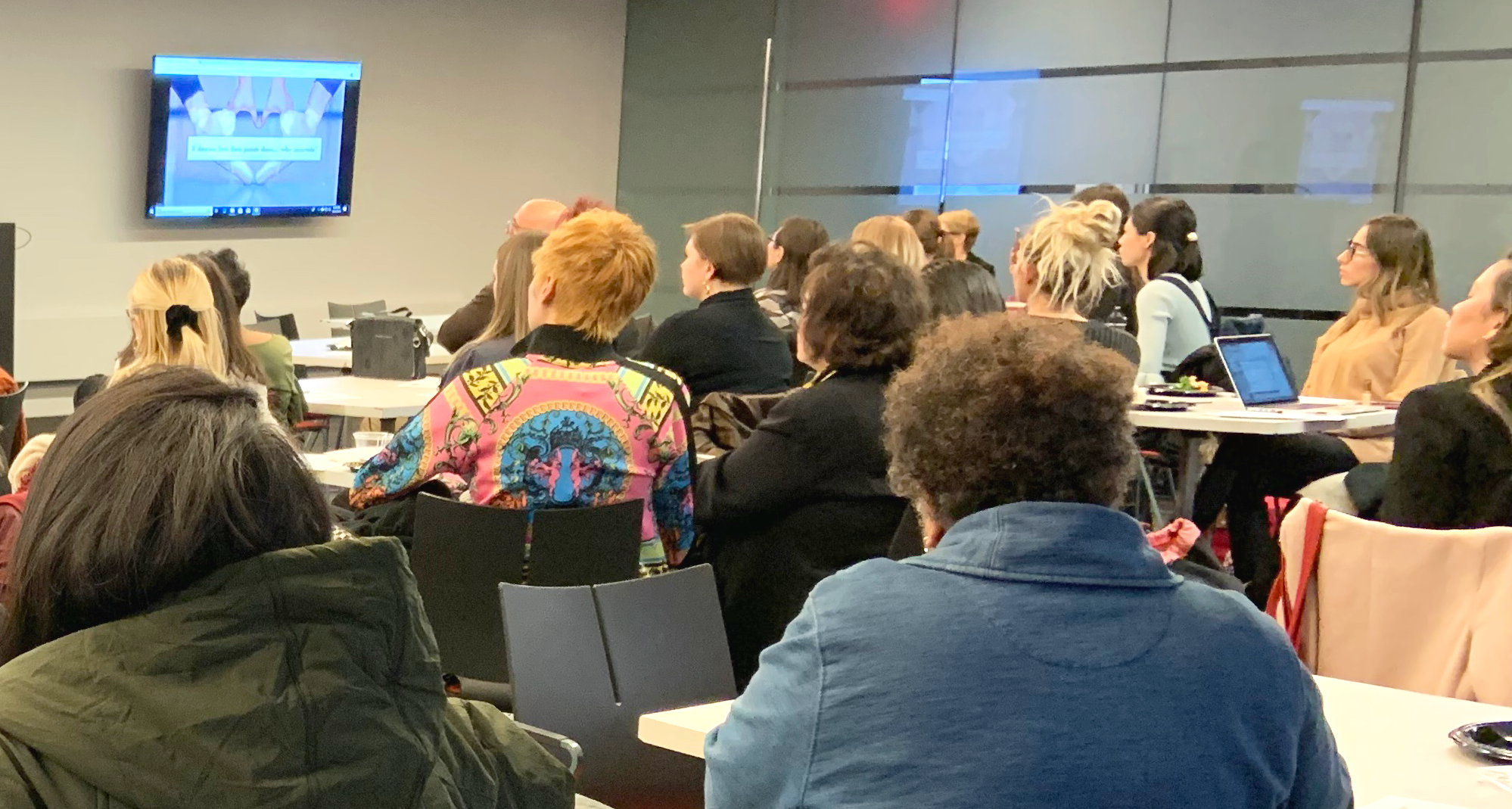 a faculty workshop, people sitting in a classroom during a presentation