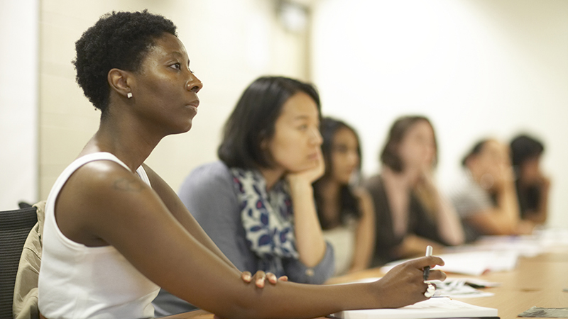 students in the classroom at the desks, listening