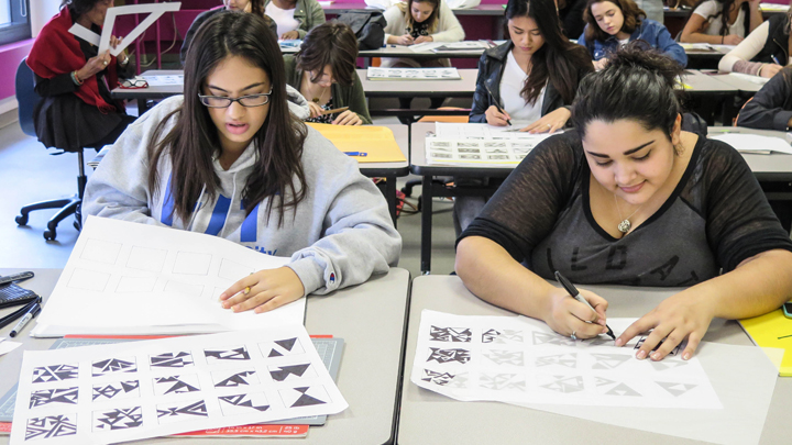 students working: tracing black and white patterns on paper