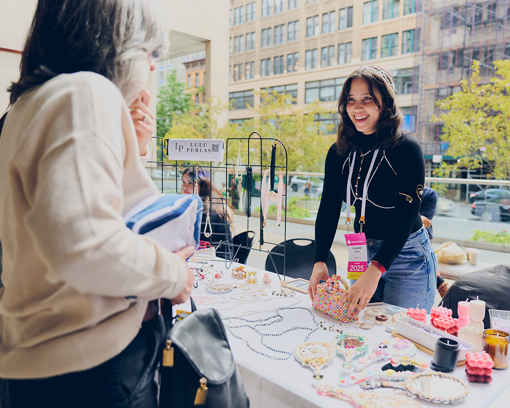 an alum selling her artisan beaded accessories at the alumni bazaar