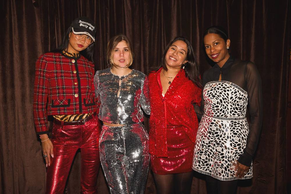 a group of alumni pose at 2025 holiday party