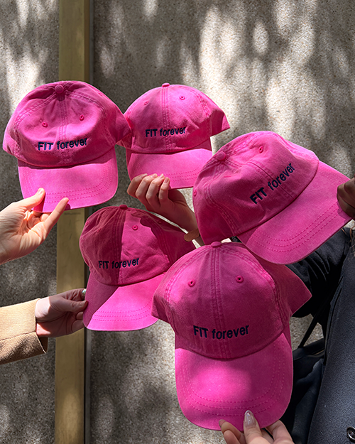Several FIT forever pink baseball hats.
