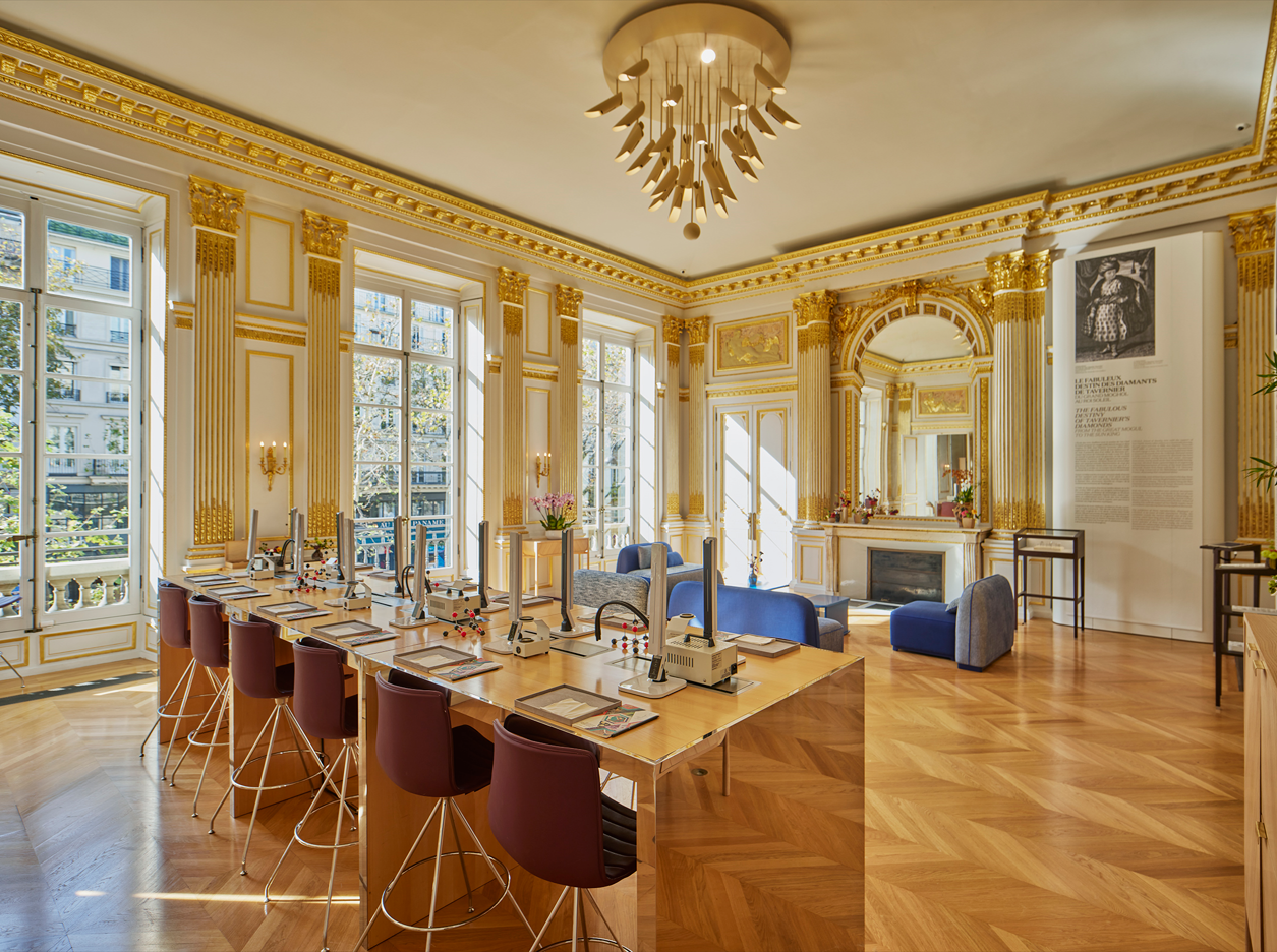 Ornate parlor room with large windows and natural lighting 