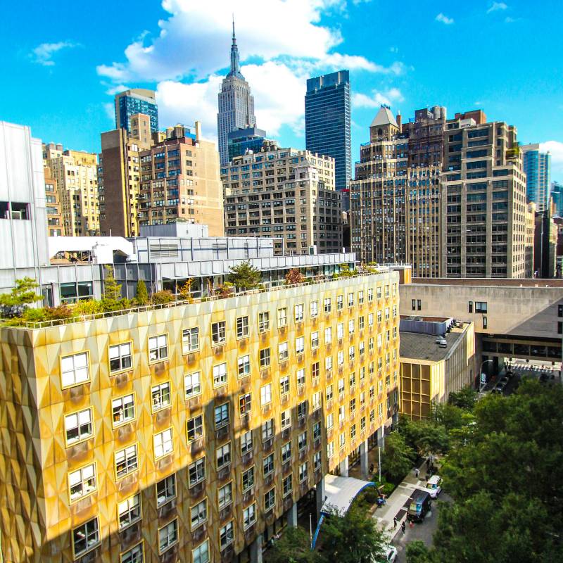 Photo of FIT campus from above, showing campus, sky, NYC skyline