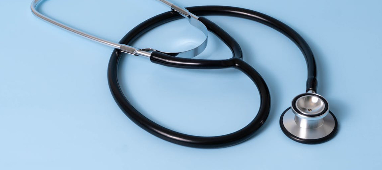 Photograph of stethoscope on blue backdrop