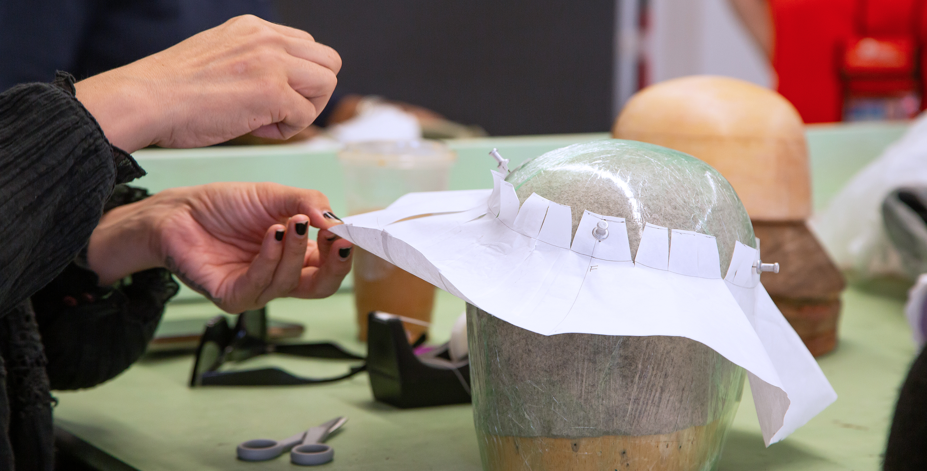 Student creating a hat