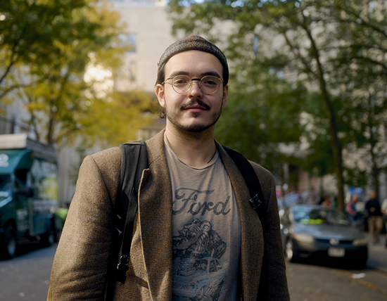 Closeup of student standing outside with a bag on shoulder