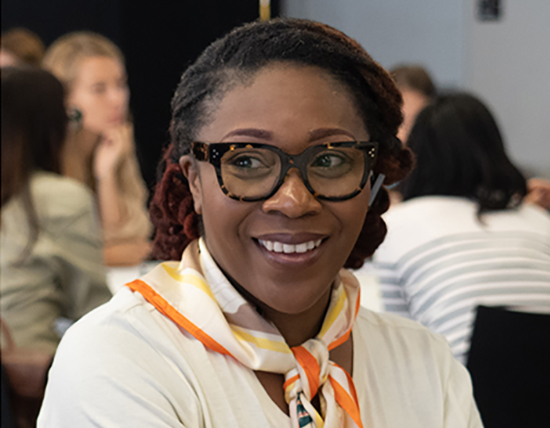 Closeup of student smiling while in a class discussion