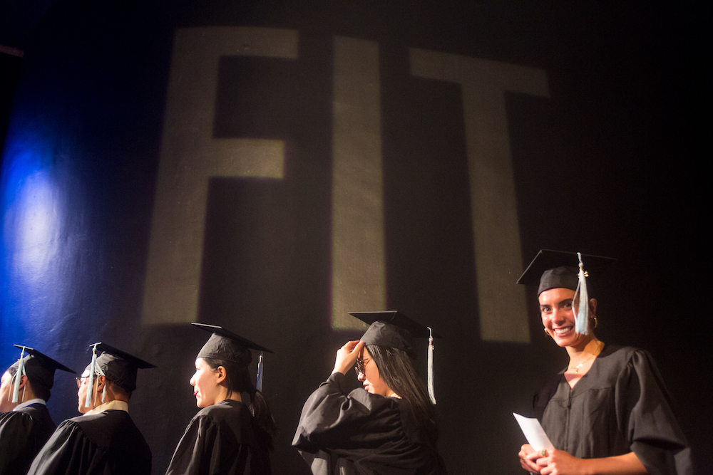 graduate students waiting in line to receive diplomas at commencement