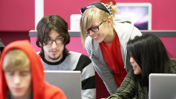 students working together at a laptop