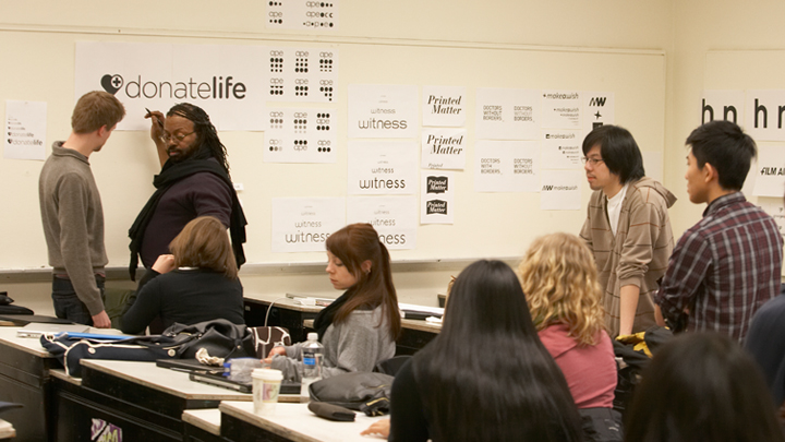 faculty member and students working on typography together