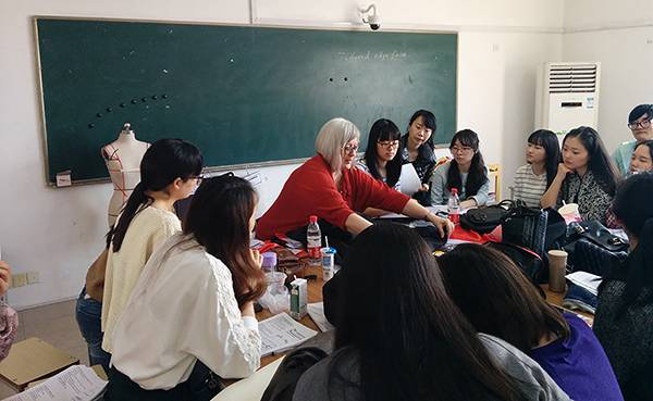 faculty member with students in a classroom.