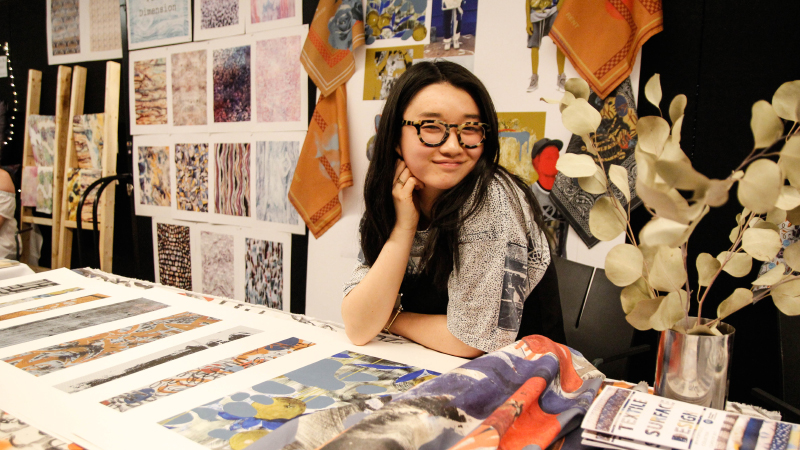 student exhibiting fabrics and mood board