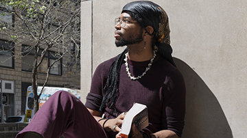 student sitting outdoors at FIT