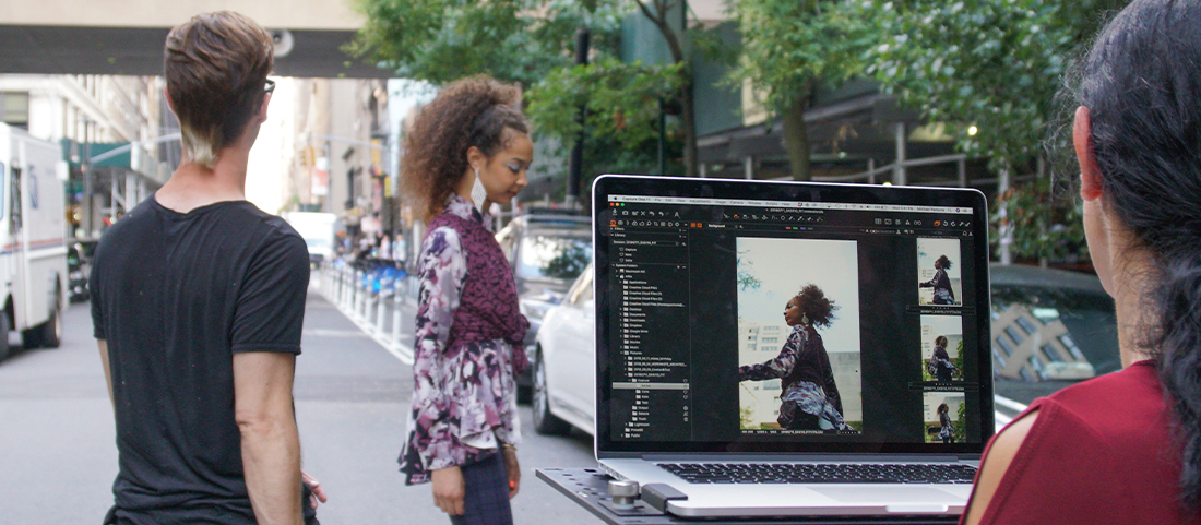 FIT students working on photography project with computer outdoors at FIT campus